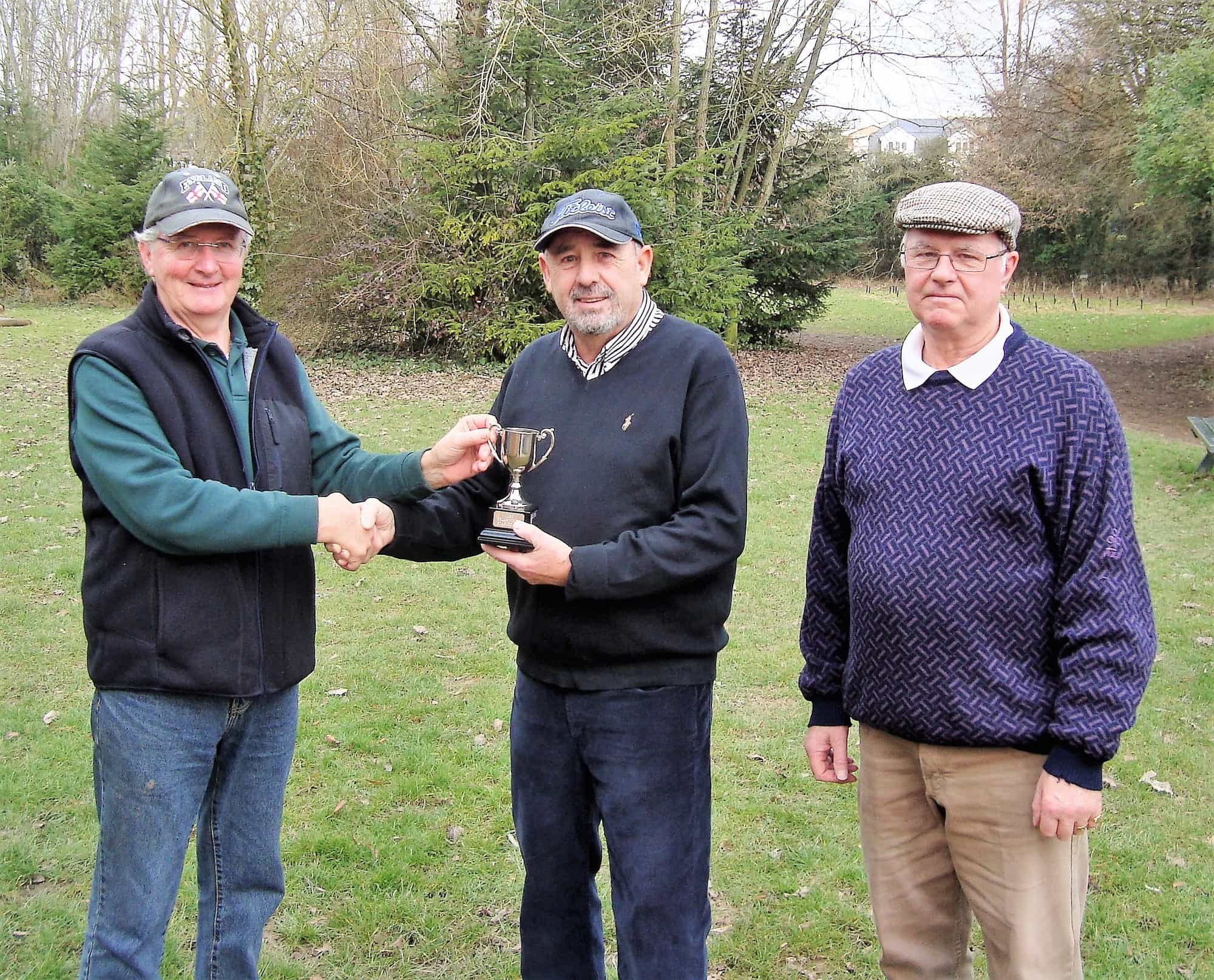 Last year’s winner, Peter Barclay (left), presents Richard Poyser (centre)with the cup in the presence of the sponsor Brian White (right).